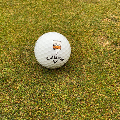 Bourbon glass Golfdotz golf ball marker for marking a golf ball.