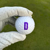 Purple letter D on Golf Ball